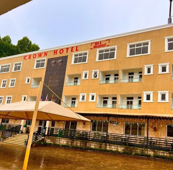The Crown Hotel facade in Kisii Town with its red hotel sign and terrace below
